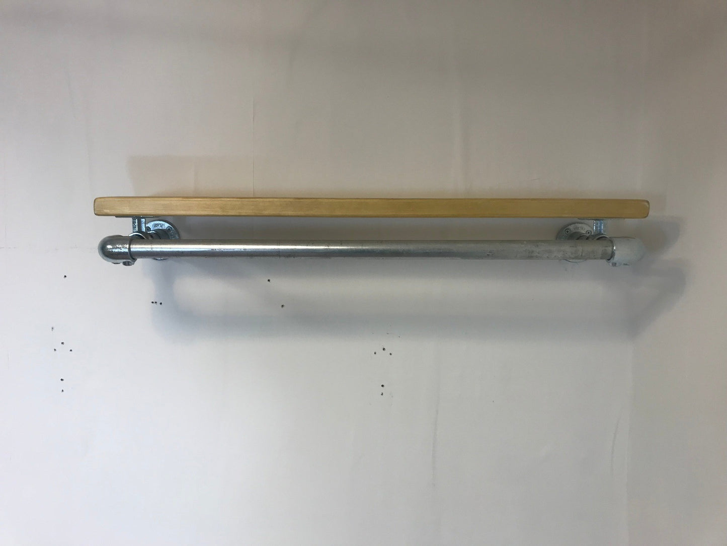 Wall fixed clothing rail with wood shelf in various widths. Black or galvanised silver.