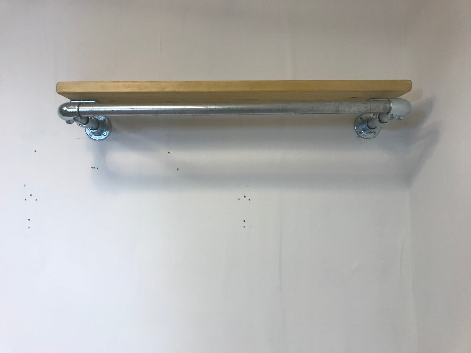 Wall fixed clothing rail with wood shelf in various widths. Black or galvanised silver.