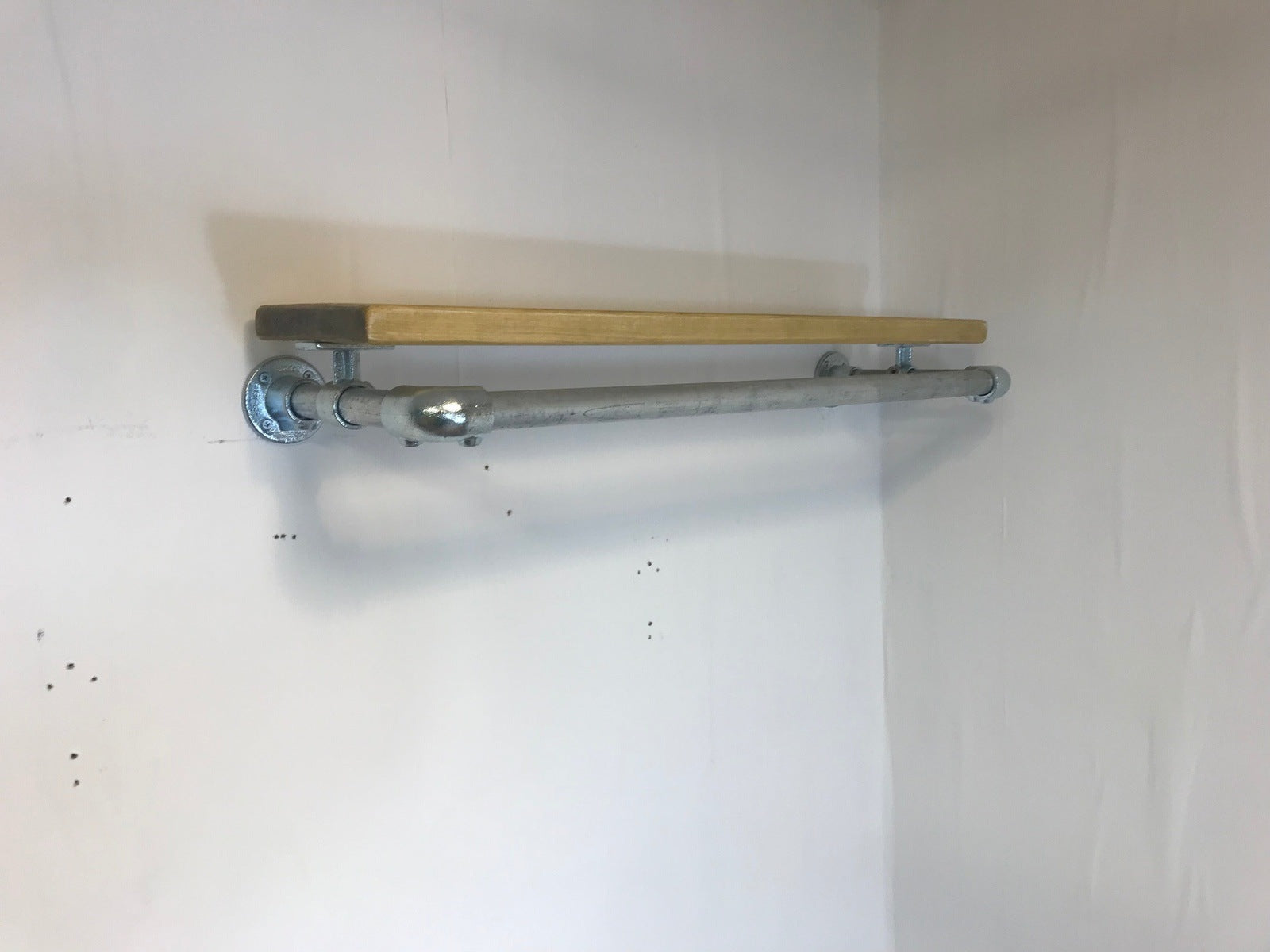 Wall fixed clothing rail with wood shelf in various widths. Black or galvanised silver.