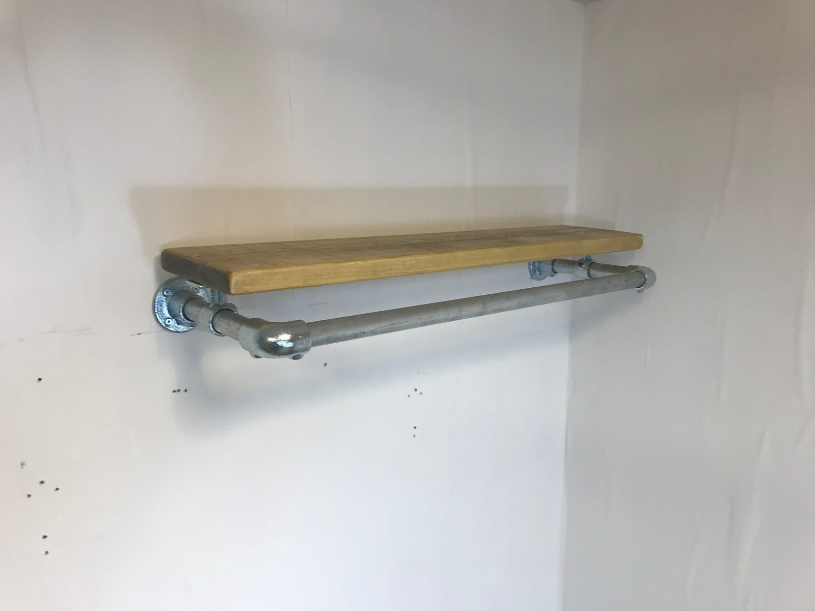 Wall fixed clothing rail with wood shelf in various widths. Black or galvanised silver.