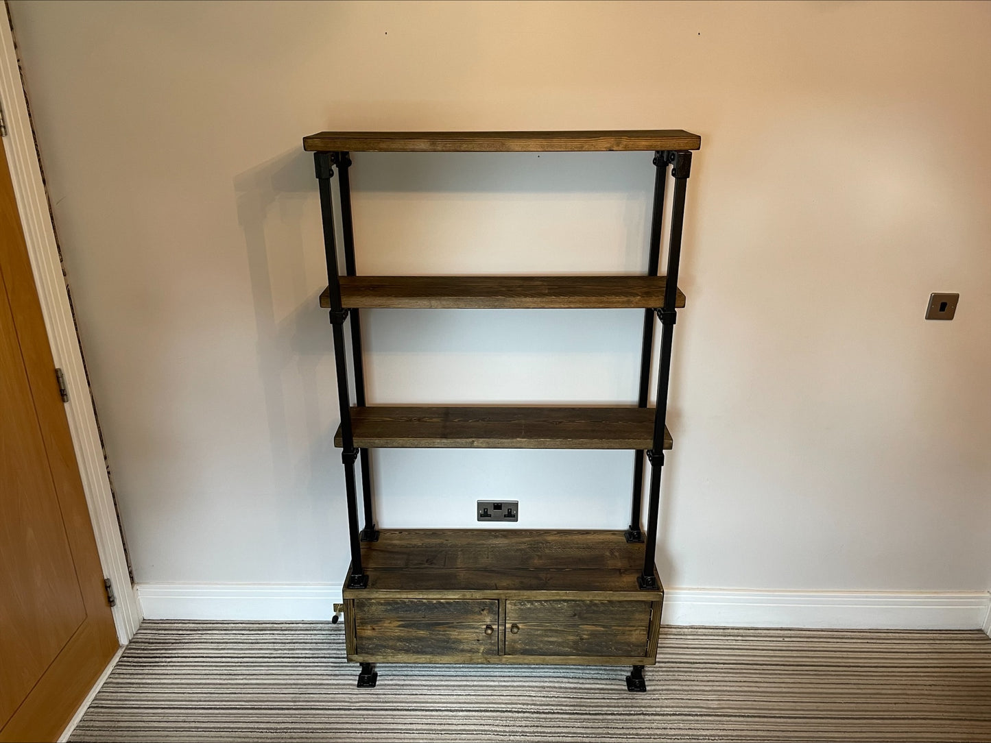 Industrial/Rustic Ladder Style Shelving Unit with Cupboard and black framework.