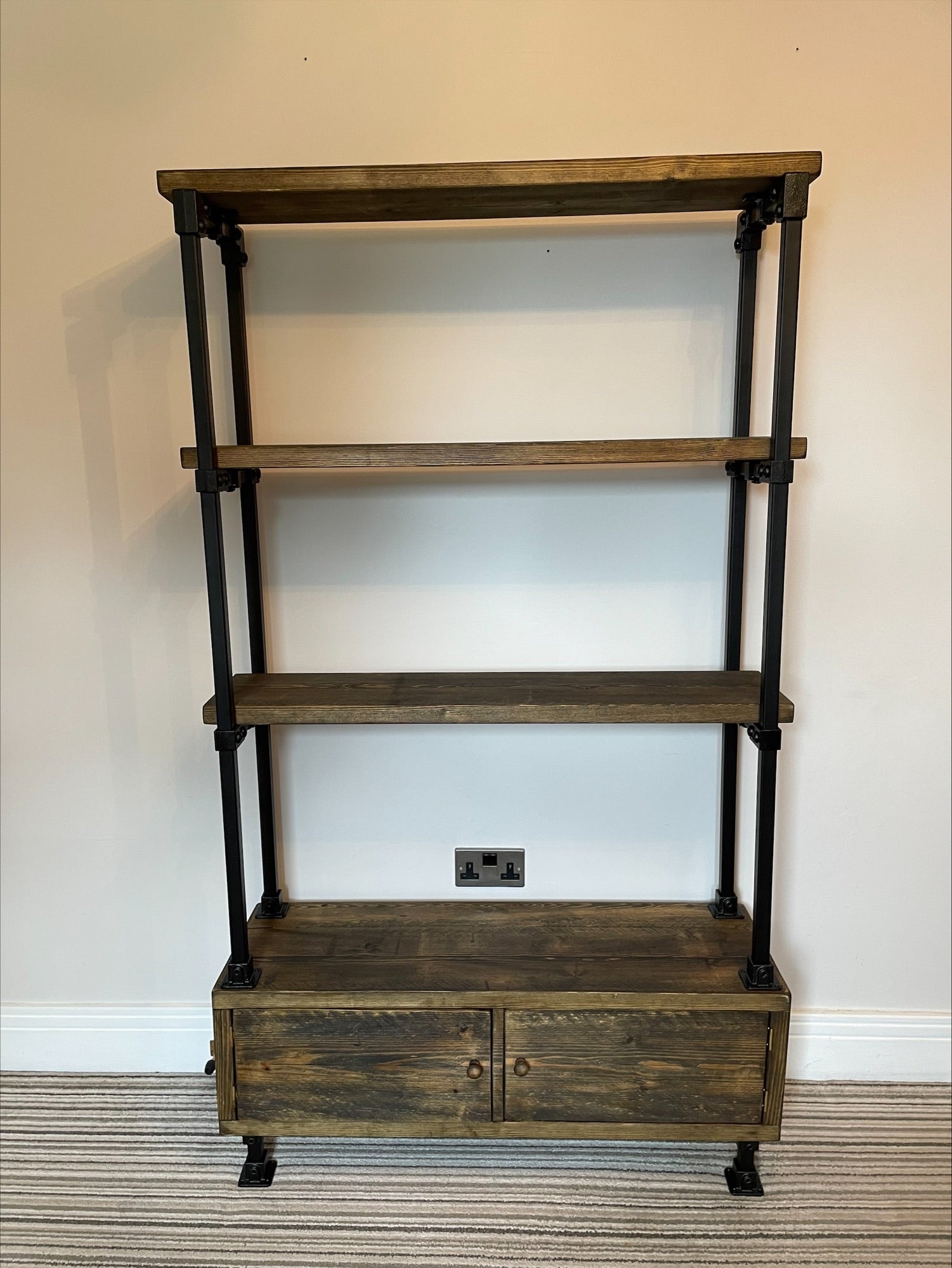 Industrial/Rustic Ladder Style Shelving Unit with Cupboard and black framework.
